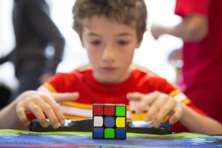 Jude Swaine, 11, prepares to be officially timed on the final day of this years annual UK Rubik's Cube Championship, held at The Forum in Stevenage, Hertfordshire.