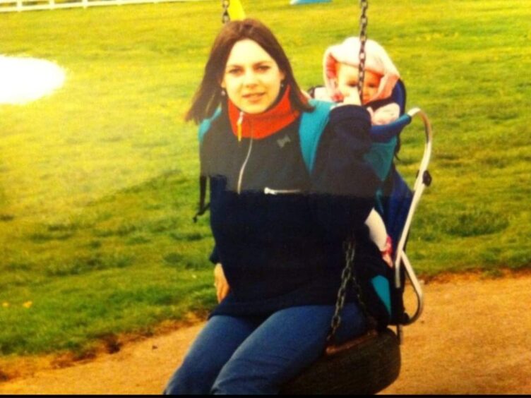 Kath on a swing with her daughter around the time her Crohn's and colitis symptoms started
