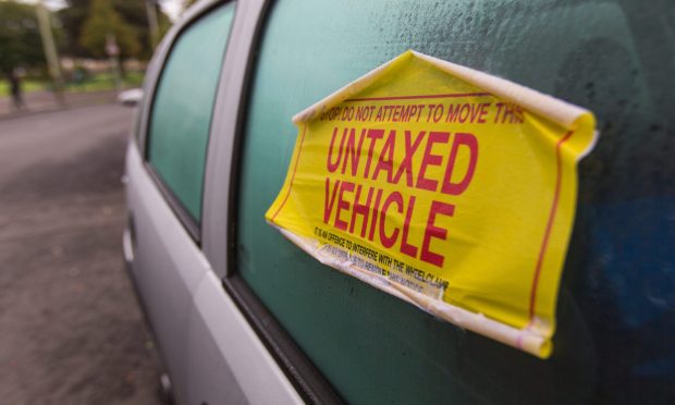 Untaxed vehicle sticker on car windscreen.