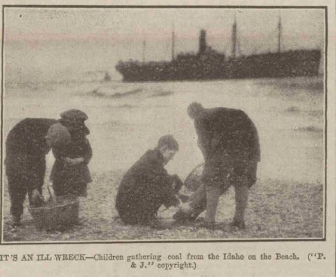 Children gathering coal from the shore after the stranding of SS Idaho at Aberdeen Beach.