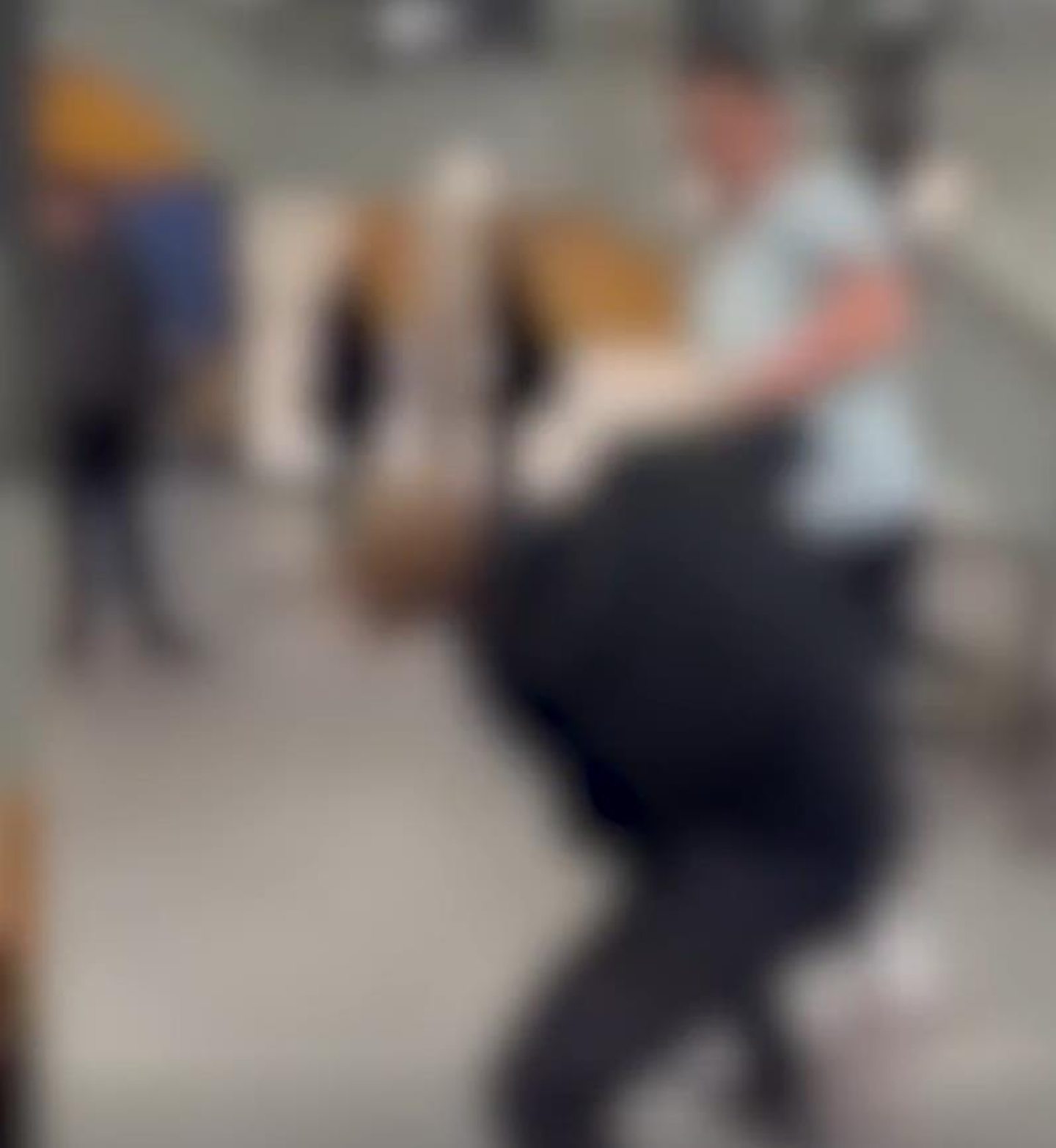 A blurred picture of a fight between two teenage boys