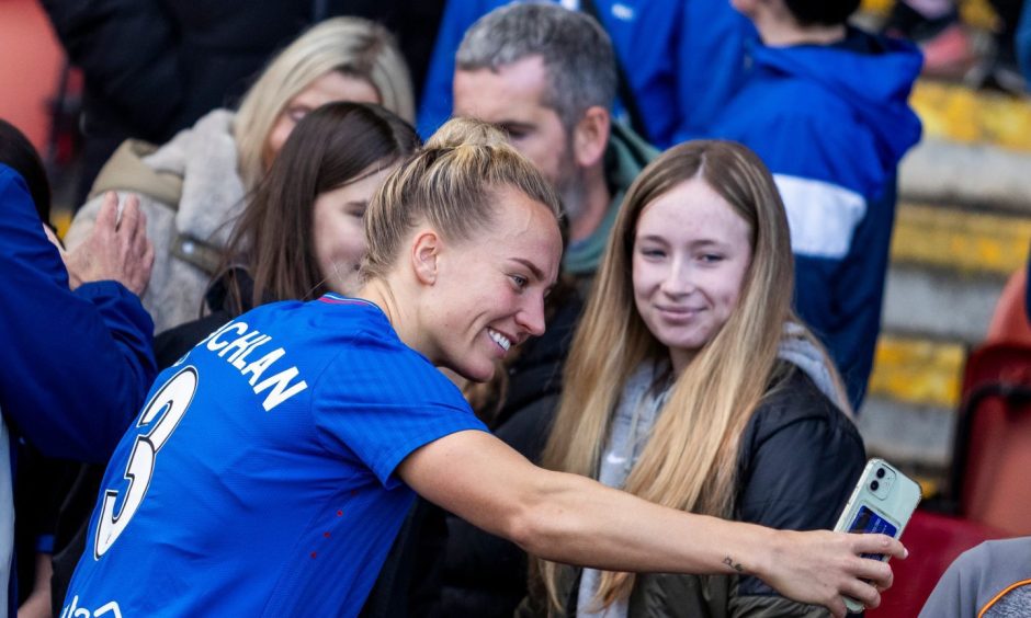 Rangers defender Rachel McLauchlan spends time taking photos with fans after a SWPL match.