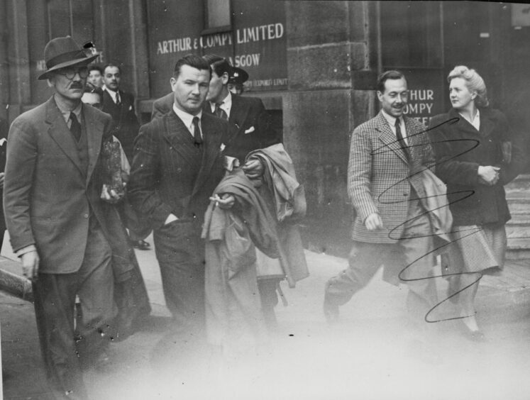 Leaving the Old Bailey during the trial of William Joyce for treason. Seen here, John Angus Mcnab, former editor of The Fascist Quarterly and close friend of Joyce. Also pictured is Joyce's brother Edward.