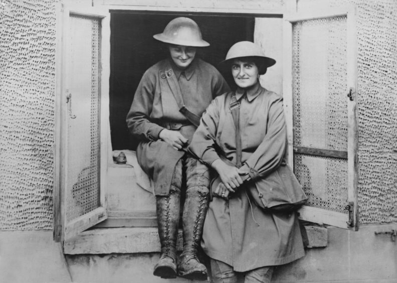 Mairi Chisholm and Elsie Knocker wearing their ambulance driver uniforms and helmets during World War I, West Flanders, Belgium, July 1917.