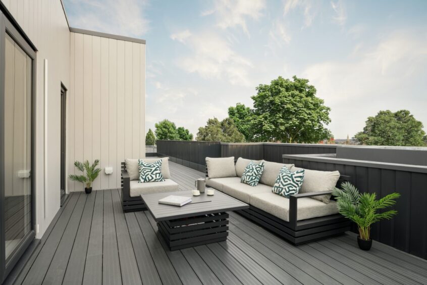 The roof terrace with an outdoor furniture set and plants