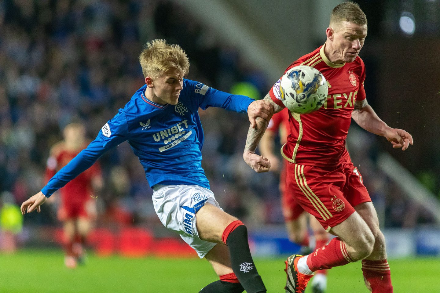 Jonny Hayes tussles with Rangers' Ross McCausland in Neil Warnock's first game in charge. Image: Shutterstock.