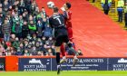 David Marshall of Hibernian catches Aberdeen striker Bojan Miovski while punching the ball. Image: Shutterstock.