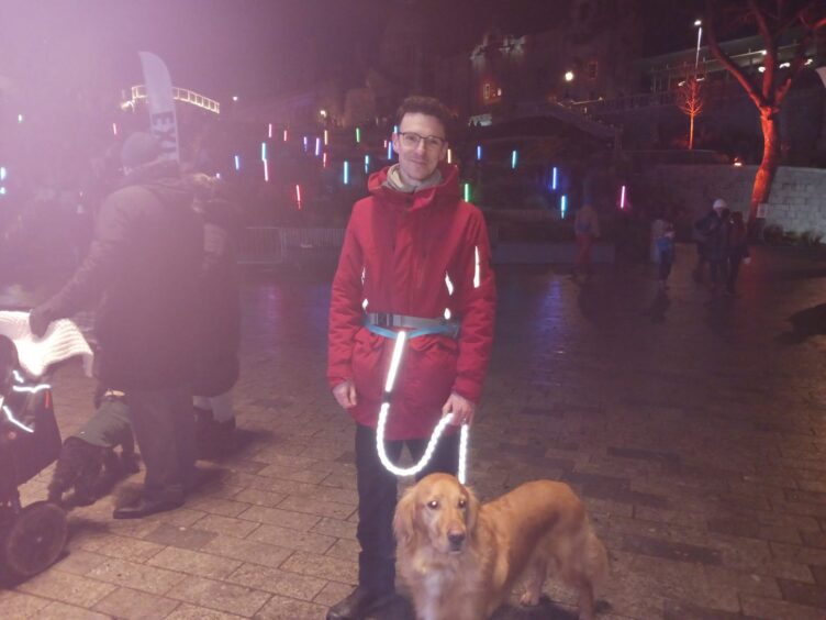 Andrew Staite standing with his dog Bailey.