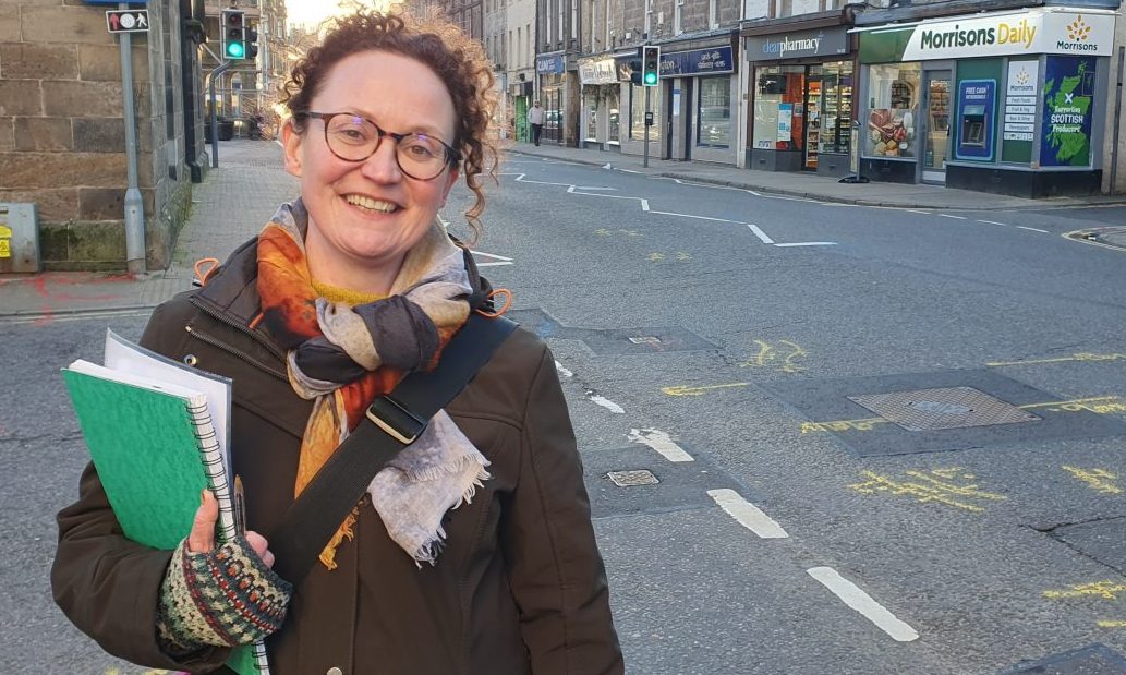 Freelance heritage consultant Helen Avenell with Forres High Street behind.