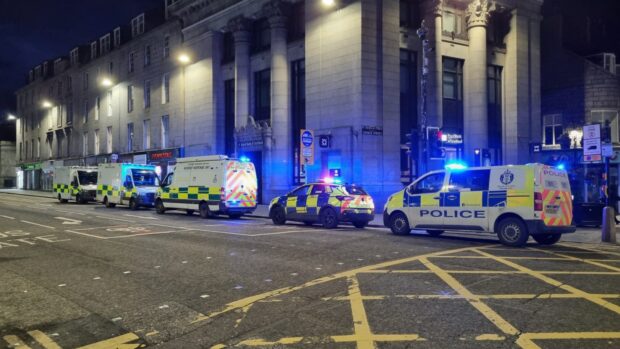 Both police and ambulances are stationed outside the bank on Union Street