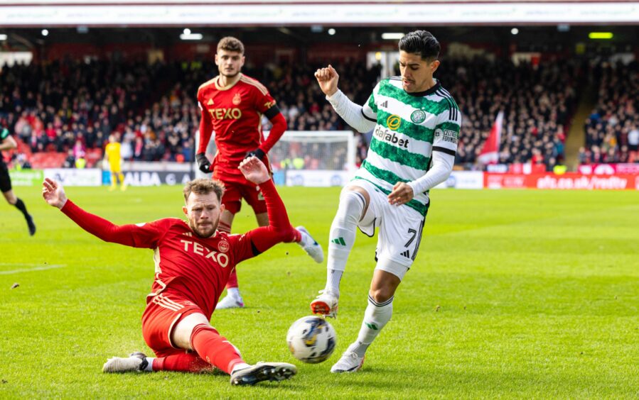 Aberdeen's Nicky Devlin and Celtic's Luis Palma in action in a Premiership match at Pittodrie.