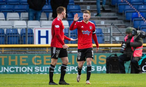 Queen's Park's Dom Thomas (right) celebrates after scoring the only goal at Inverness. Images: Paul Byars/SNS Group