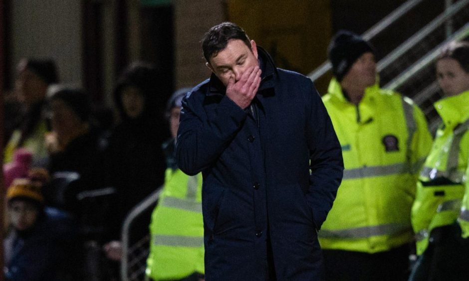 Ross County Manager Derek Adams looks dejected as his side fell to a 5-0 defeat at Motherwell on Tuesday. Image: SNS.