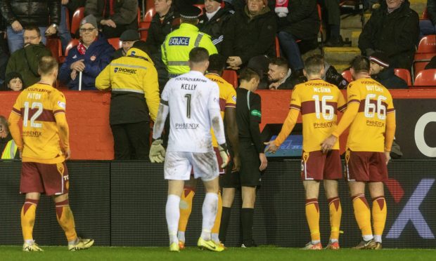Referee Kevin Clancy goes to VAR to check a possible foul in the build up to Motherwell's Harry Paton's goal against Aberdeen which was chalked off. Image: SNS.