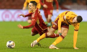 Aberdeen's Jamie McGrath is tackled by Motherwell's Paul McGinn. Image: SNS.