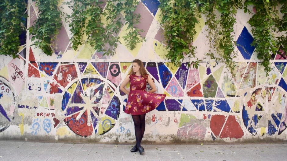  Sophie Stephenson dancing with a colourful mural behind her