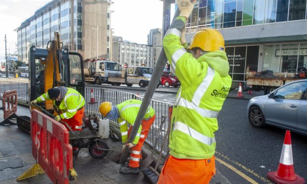 Council workers installing pole for LEZ sign