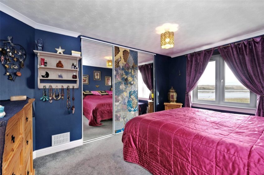 One of the bedrooms in the Newburgh property. navy blue walls as well as sculptures, wall hangings and statuettes from the Aberdeenshire couple's travels.