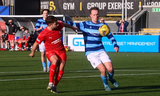 Millar Gamble, in red, has signed a new two-year deal with Brora Rangers