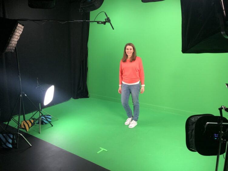 Sophie Stephenson on set for Beathaichean CBeebies with a green screen behind her