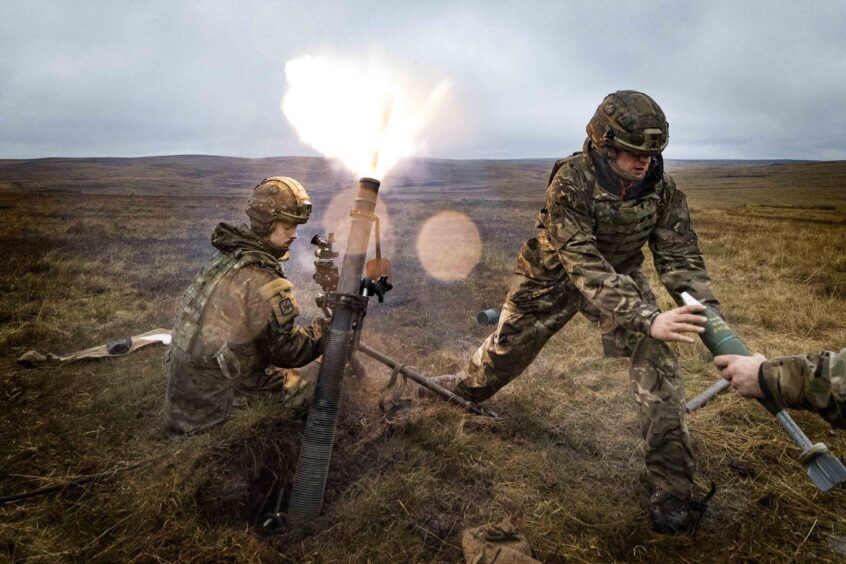 Soldiers in training firing missiles.