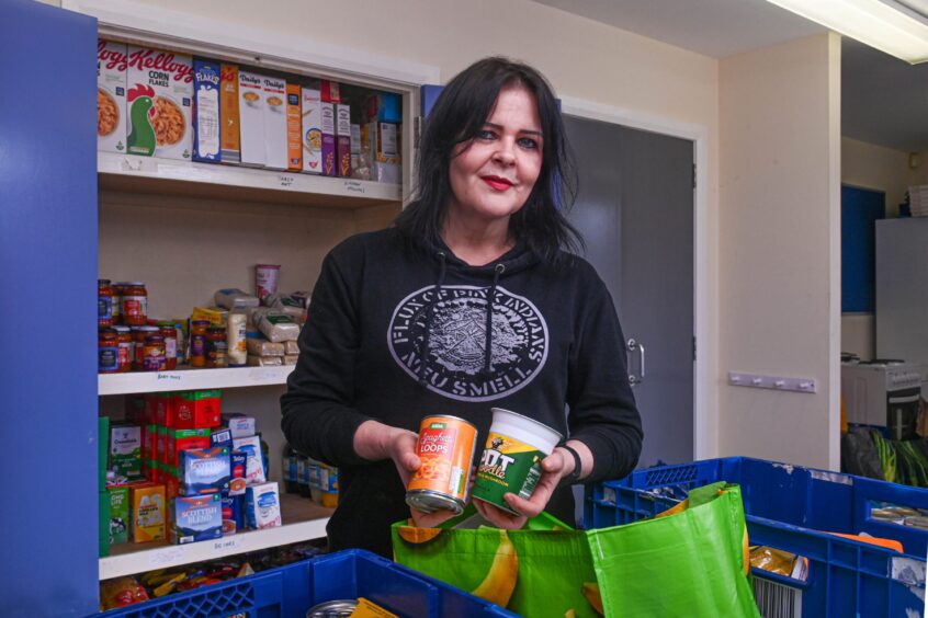 Fiona Young holding food donations at the Aberdeen foodbank.