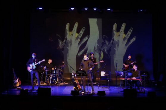Daniel Taylor and the band in Something About George, The George Harrison Story. Image David Munn Photography.