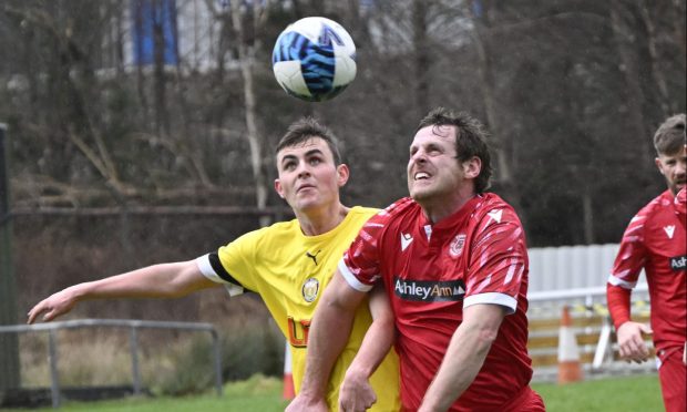 Fort William's Andrew Sneddon and Thurso's Stuart Sinclair compete for the ball.