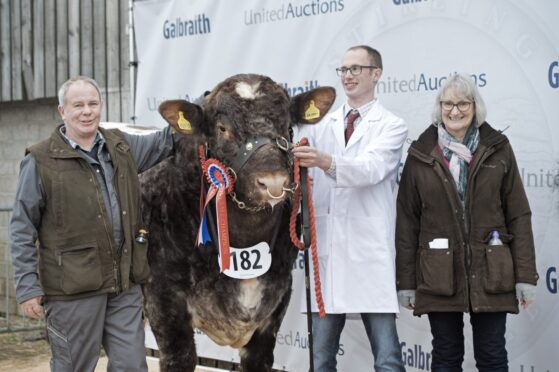 Grant Stephen with his winning bull Glendual Sammy and his parents Sandy and Gillian from Dallas, Forres.