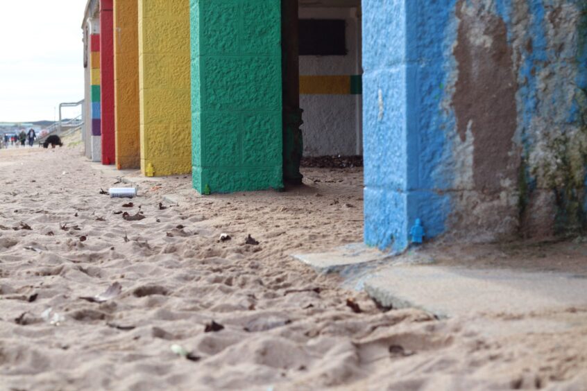 Colourful Lego-style figures blend into walls at Aberdeen beach.