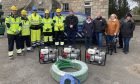 The Kintore resilience group received flood defence equipment from SSEN.
