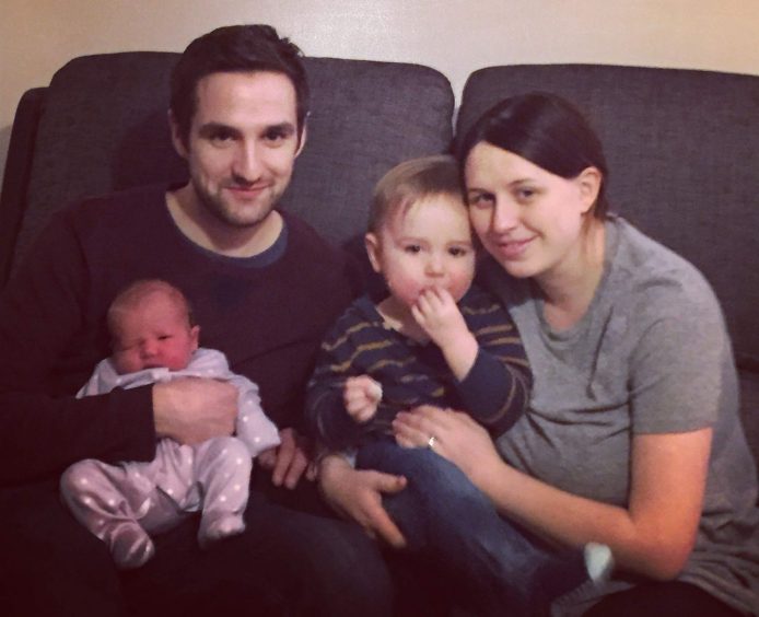 Pictured with his young family is Iain McGettrick holding new born Olivia, with wife Jenna next to him who is holding their son Luke. 