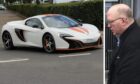 A McLaren supercar and Jason Webber, who crashed his van into one on the NC500