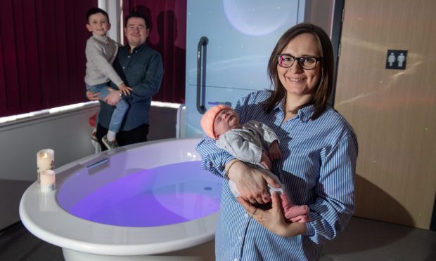 Natalie Mackie stands beside the birthing pools in Inverurie with partner Stuart Sproat and son Oscar.