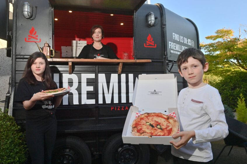 Ruth with daughter Isla and son Ethan outside their Milltimber pizza trailer.