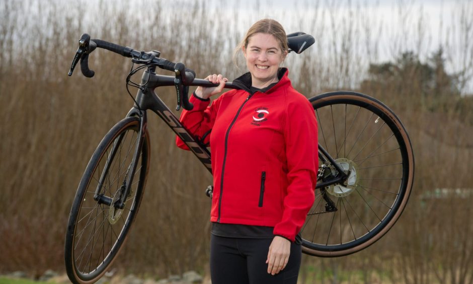 Aberdeen triathlon coach Tamsin Law with her bicycle.