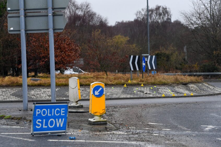 "Police Slow" sign at scene of crash at the A96 Broomhill roundabout. 