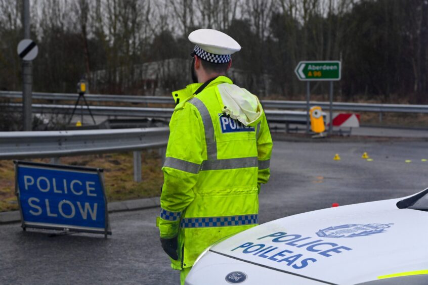 Police officer at scene of crash on A96 near Kintore.