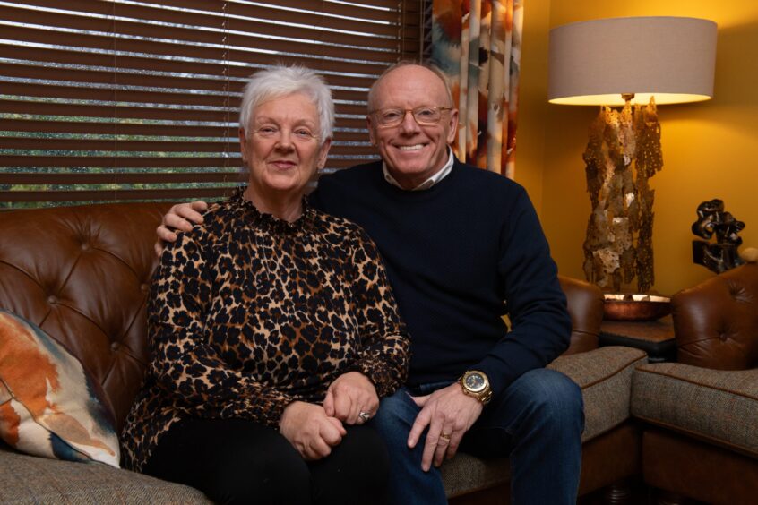 Carol and Charlie Bain sit on a sofa at their home in Bridge of Don.