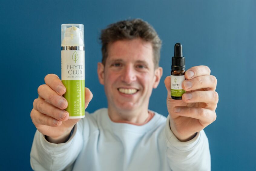 P&J health reporter Andy Morton holds out the CBD products he is testing