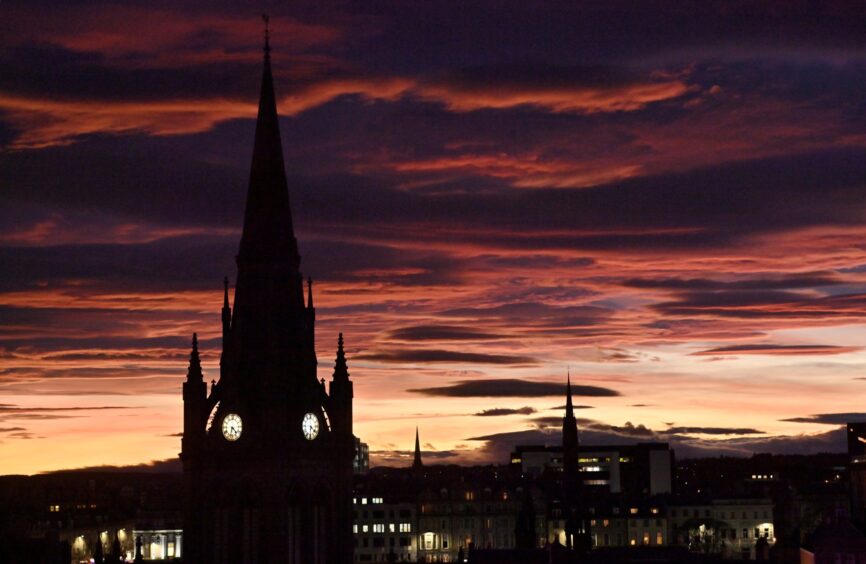 The sunset behind the clock tower of the Kirk of St Nicholas in Aberdeen.