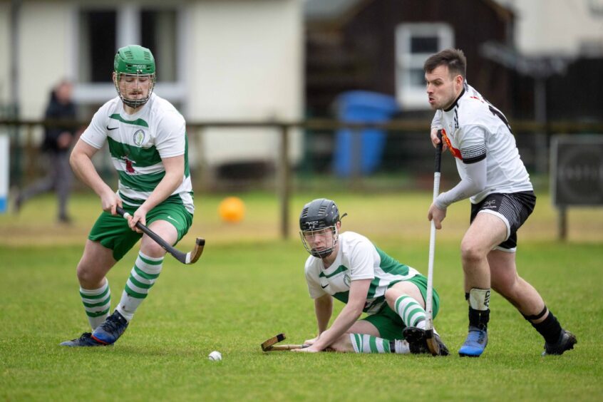 Oban Celtic's Joe MacVicar (left) and Finlay Cameron with Greg Matheson (Lovat). Image: Neil G Paterson.