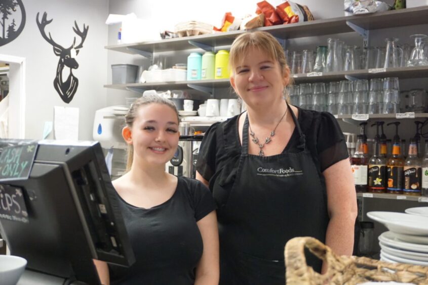 Lorraine Comfort and Abbie Miller smiling behind the counter at Comfort Foods, which serves budget-friendly food in Inverness