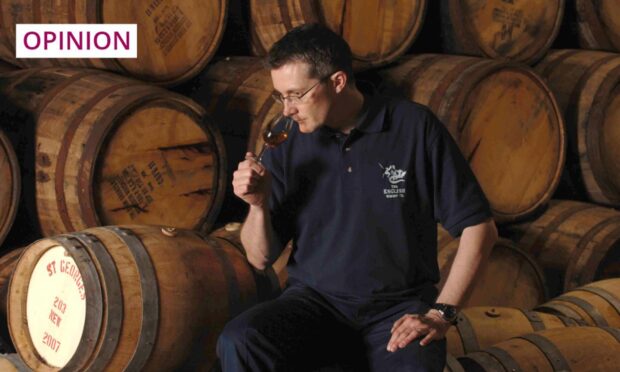 Distiller David Fitt samples a dram made by the English Whisky Co in Norfolk. Image: Albanpix/Shutterstock