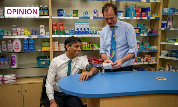 Prime Minister Rishi Sunak has his blood pressure checked by a pharmacist. Chemists in England  can now assess and treat patients for certain conditions without oversight from a GP. Image: Ben Birchall/PA Wire