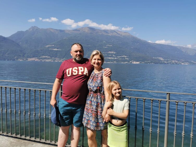 Bridge of Don dad Mario Korzycki with his partner and daughter on holiday with mountain and water behind him.