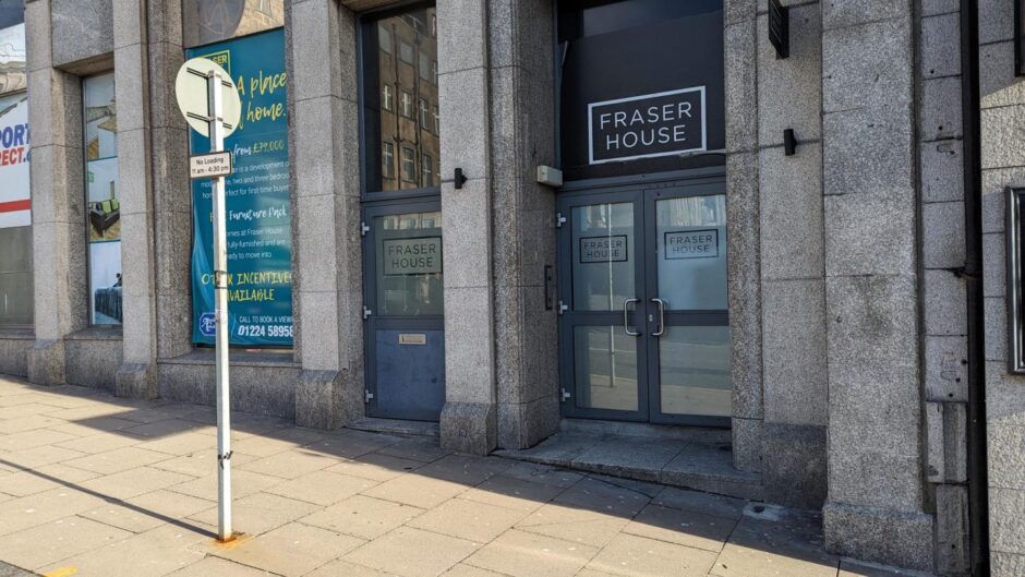 Fraser House's entrance is nextdoor to Sport Direct. Residents claim sex workers come down to the door in bathrobes to greet clients to their Airbnbs. Image: Alastair Gossip/DC Thomson