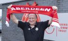 Aberdeen's interim manager Neil Warnock holding up an Aberdeen FC scarf