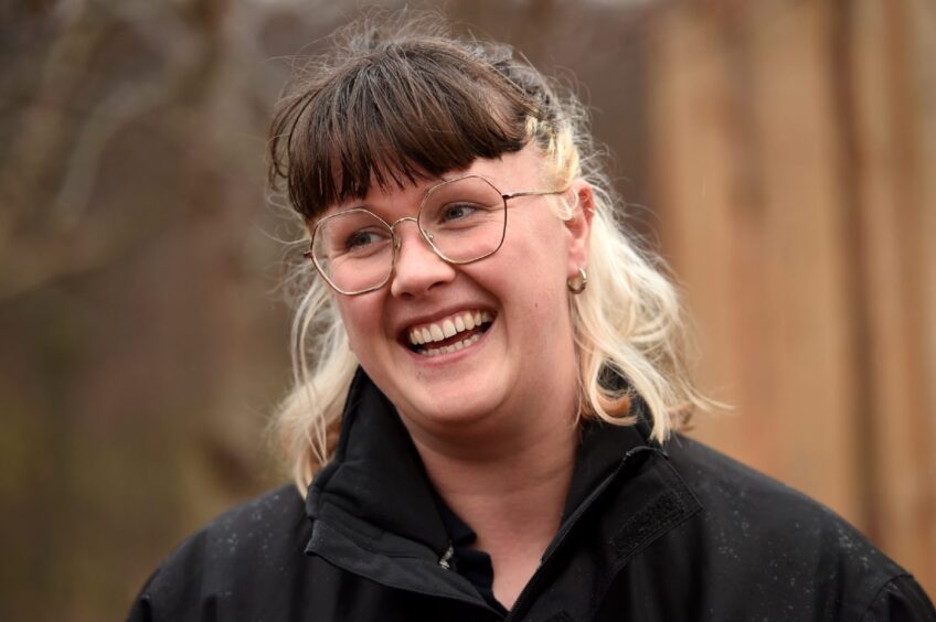 Rebecca Amos dressed in a black top and wearing glasses.