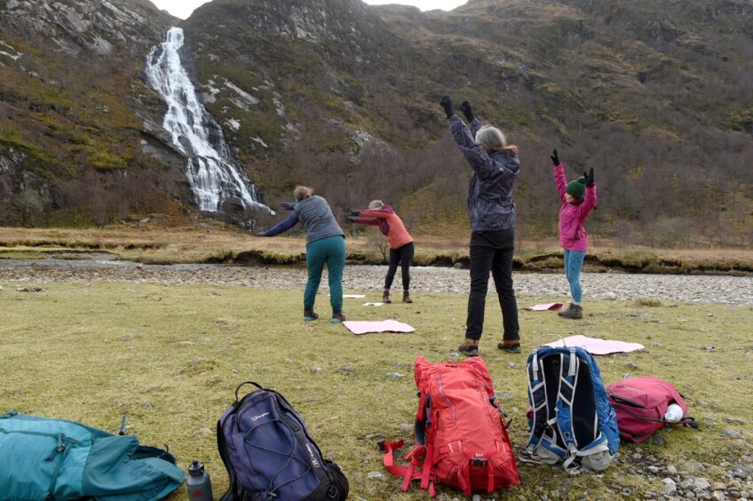 The wild yoga session in action in the shadow of Steall Falls. Image: Sandy McCook.